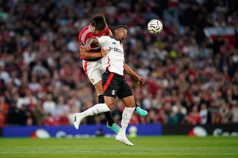 Manchester United Vs Fulham: Harry Maguire, left, challenges Fulham's Rodrigo Muniz